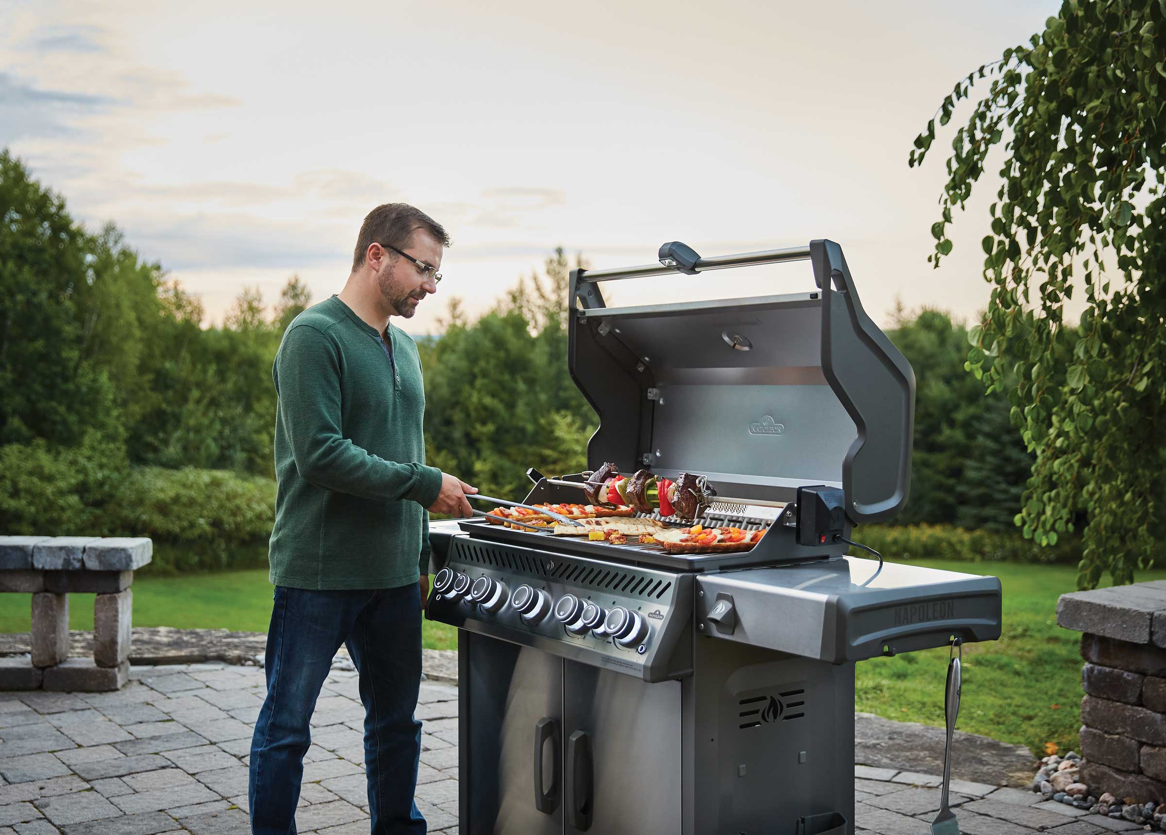 Man grilling outdoors on a Napoleon Grill
